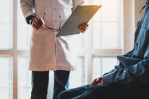 Doctors hold papers to check the sexual health of a male patient.