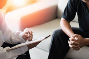 Man talking with doctor about symptoms of low testosterone in Hartford, CT