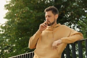 Man smoking, contributing to his Peyronie's Disease in Hartford, CT