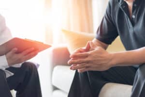 Man meeting with urologist in Hartford, CT, to discuss testicular cancer signs