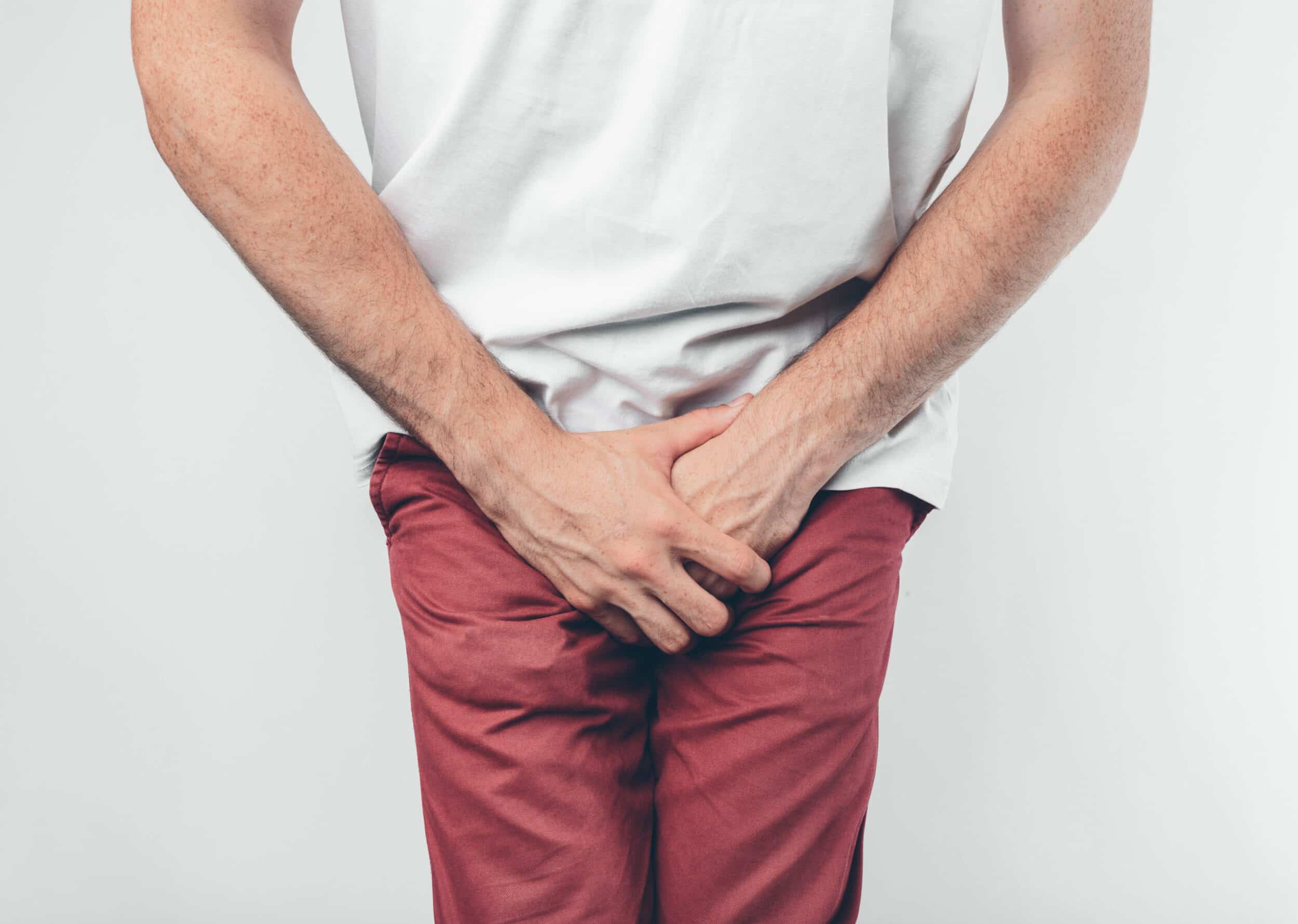 Man holding his private area due to urge to urinate from overactive bladder in Hartford, CT